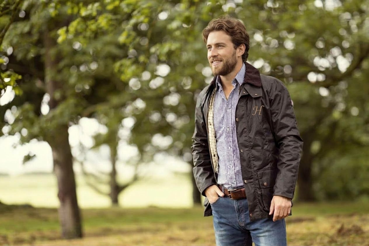Brackenfield wax jacket in brown with a cord collar and the Harland H, worn among oak trees